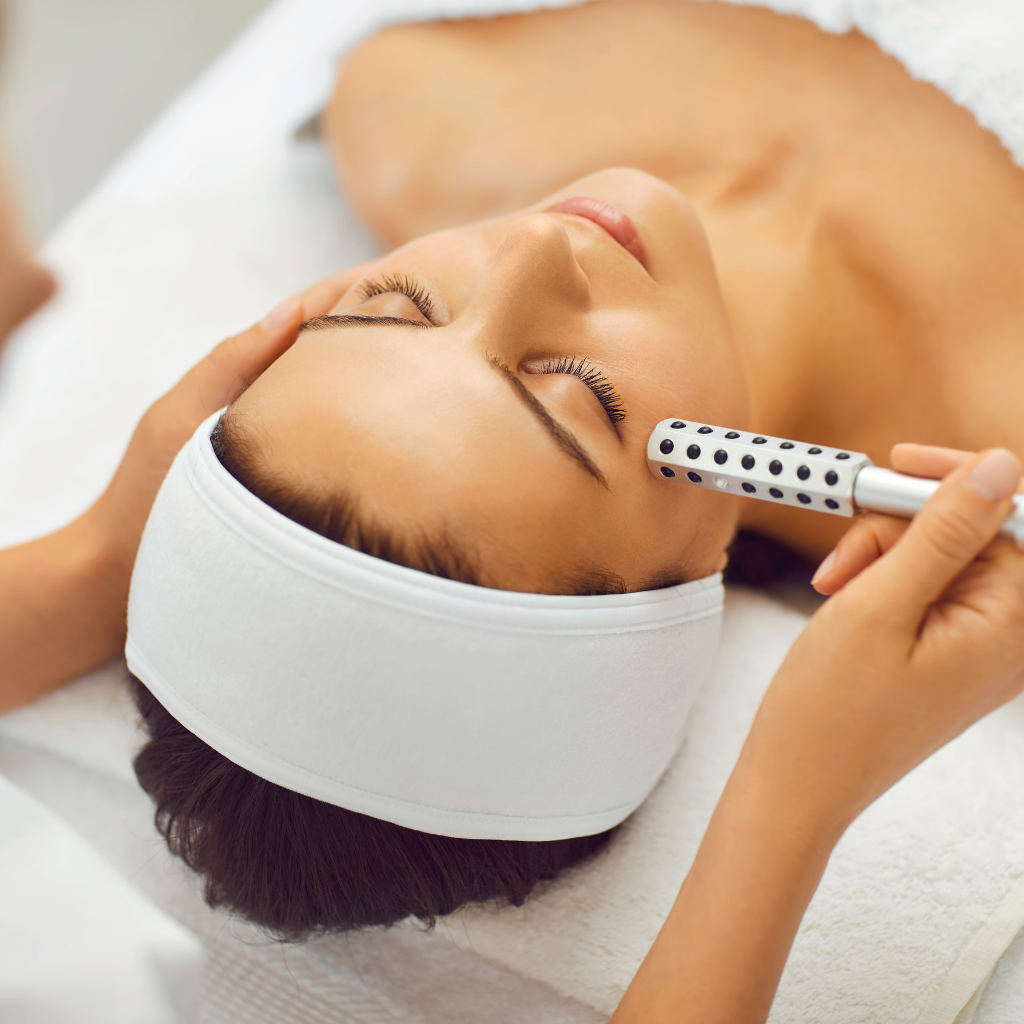 A woman receiving a facial treatment in a spa