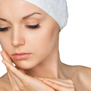 A woman in a spa headband gently touching her face